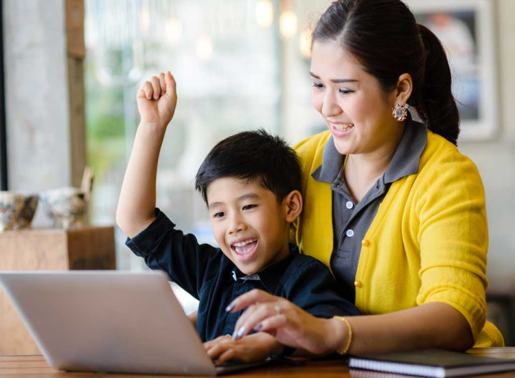 97946616 Mother and son at computer